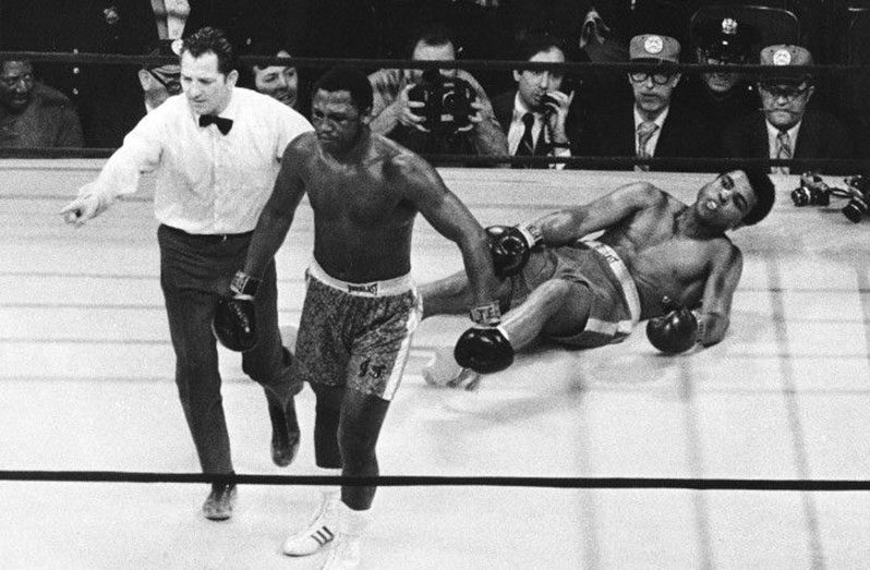 Joe Frazier is directed to his corner by referee Arthur Marcante after knocking down Muhammad Ali during their heavyweight title fight at Madison Square Garden in New York on March 8, 1971.