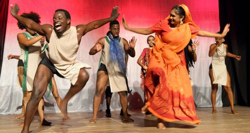 Kijana Lewis (left) and his troupe of dancers depicting interracial unity during one of his performances
