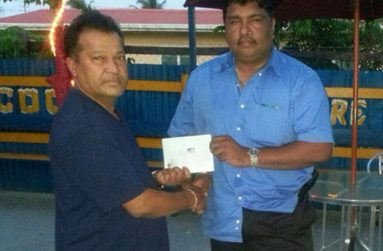 Here you go sir. Mr Ramoo Singh of the USA (left) hands over the cash to Anil Beharry the Secretary/Treasurer of the Young Warriors Cricket Club.
