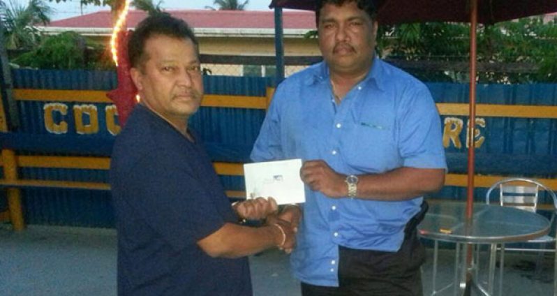 Here you go sir. Mr Ramoo Singh of the USA (left) hands over the cash to Anil Beharry the Secretary/Treasurer of the Young Warriors Cricket Club.
