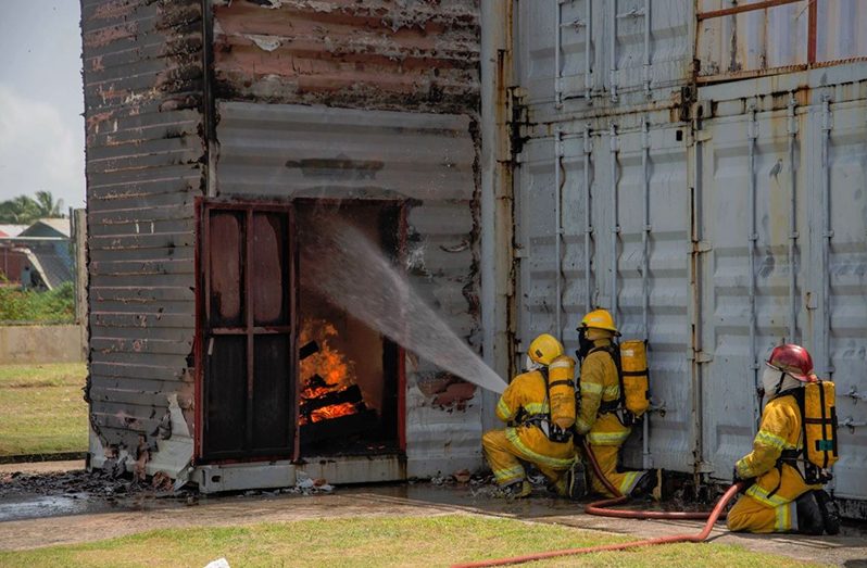 The new graduates undertaking a fire drill exercise (Marceano Narine/DPI photo)