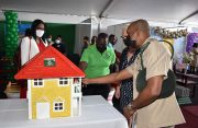 Director of Prisons (ag), Nicklon Elliot (right), shows the British High Commissioner to Guyana, Jane Miller (second right), one of the model houses that was designed by prisoners. Also in the photo is Permanent Secretary of the Ministry of Home Affairs, Mae Toussaint Thomas (Elvin Croker photo)
