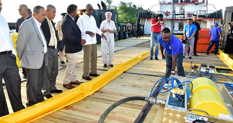 An employee of GAICO Construction and contracting Services demonstrates the use of
equipment on board the company’s supply /spill response vessel on Friday afternoon.
President David Granger (centre) engages the company’s principal, Komal Singh, as Private
Sector Commission (PSC) chairman Eddie Boyer (left) and Minister of Public Health , Dr
George Norton, look on [Adrian Narine photo]