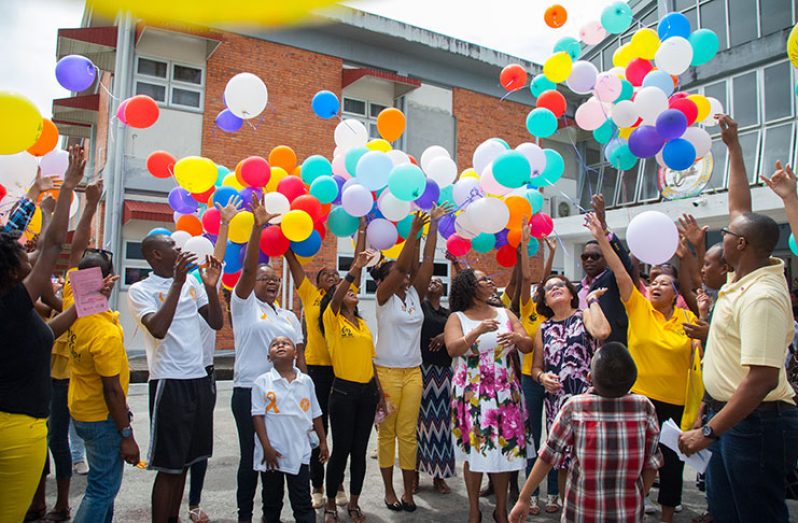 First Lady, Mrs. Granger and Minister of Public Health, Volda Lawrence, join with the Rotaract Club of Georgetown Central, The Giving Hope Foundation and other organizations in releasing 300 balloons into the air to support all persons, especially children, affected by cancer . [Delano Williams photo]