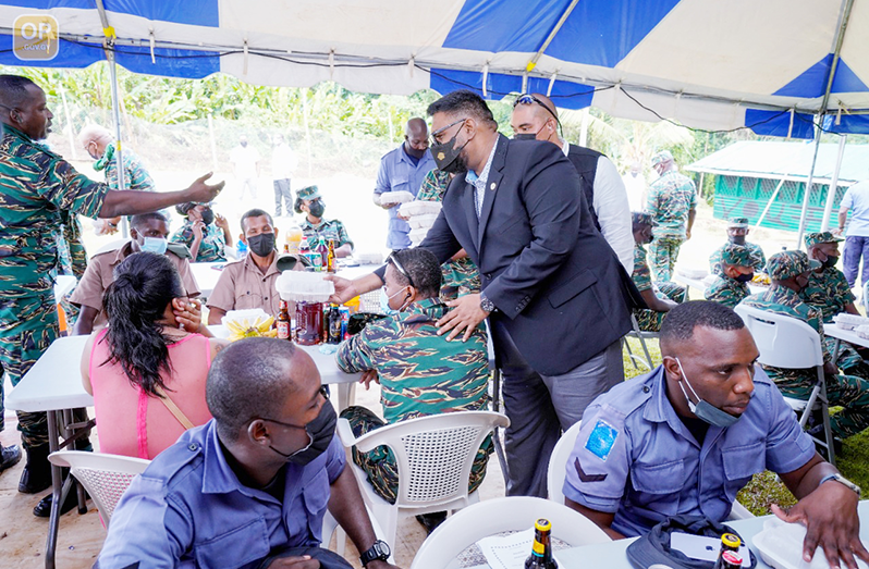 President, Dr Irfaan Ali serving Guyana Defence Force ranks at Camp Everard, in Mabaruma, on Monday at their annual Christmas Luncheon (Office of the President photo)