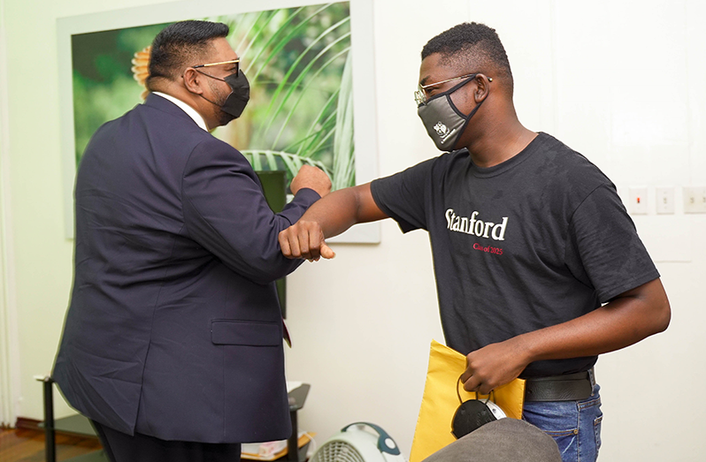 President Dr. Irfaan Ali greets Sherlock Junior Langevine during a brief meeting at State House on Friday.
President Ali has promised to support Langevine’s dream of attending Stanford University by offsetting
the additional expenses of the scholarship awardee (Office of the President photo)