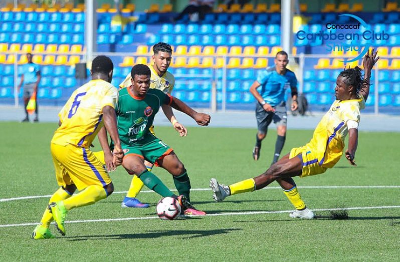 Swarmed! Fruta Conquerors’ Eon Alleyne is swarmed during his side’s 2-0 defeat in Curacao.