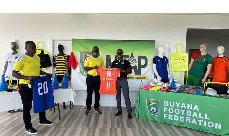 Colin Gittens, president of the GFF Elite League Champions, Fruta Conquerors, receives uniforms from GFF president Wayne Forde. (GFF photo)