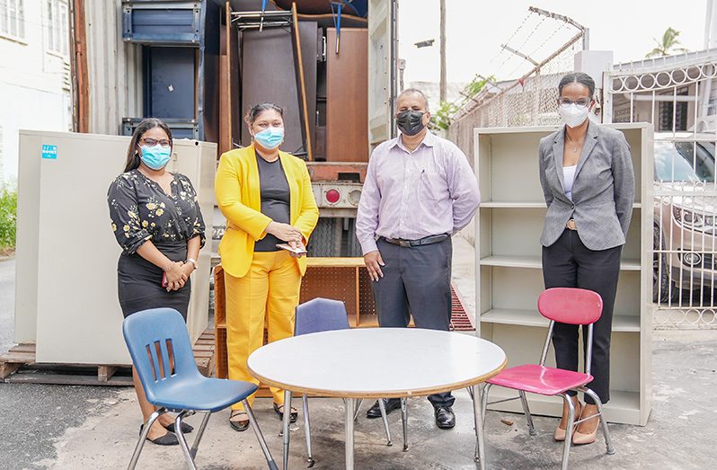 From left: Coordinator of the Book Distribution Unit, Darshini Balac; Education Minister, Priya Manickchand; CEO of Food For The Poor (Guyana) Inc; Kent Vincent and the organisation’s Public Relations Officer, Jonelle DeViera, with some of the donated pieces of furniture