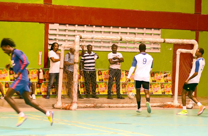 Action in Wednesday evening’s quarter-final of the Legacy ‘Magnum Mash Cup’ Futsal tournament at the National Gymnasium. (Adrian Narine photo)