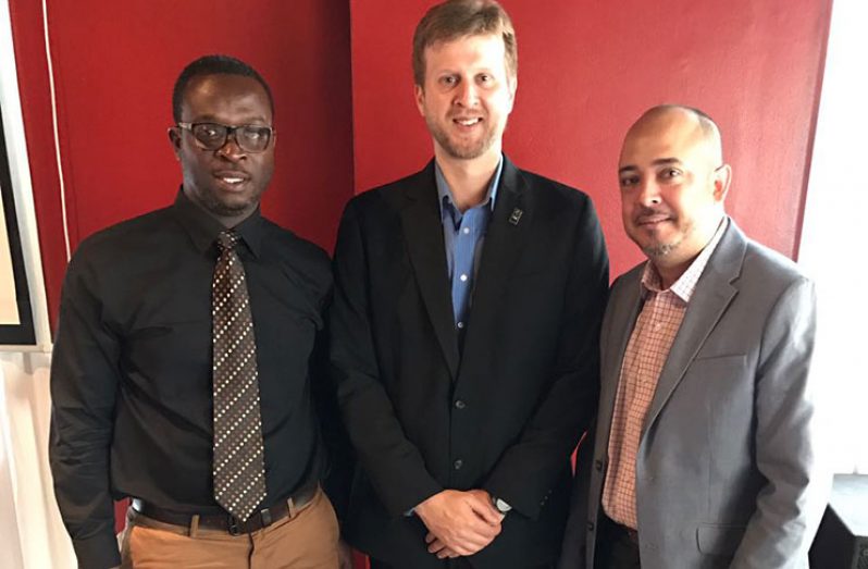 Victor Mansure, FIBA’s Assistant Executive Director (C), flanked by vice-president of the GABF, Michael Singh (first from left), and GABA president Junior Hercules. (Rawle Toney photo)