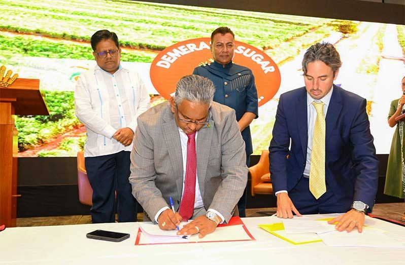 CEO of GAICO, Komal Singh and CEO of Sucro, Jonathan Taylor, sign the joint venture for the US$20 million sugar refinery