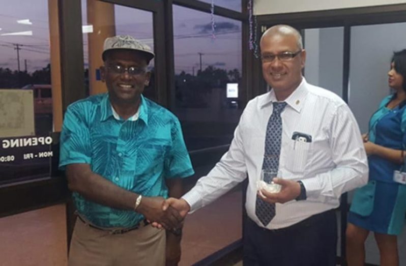 Branch Manager Dev Persaud warmly greets a rice farmer during the reception