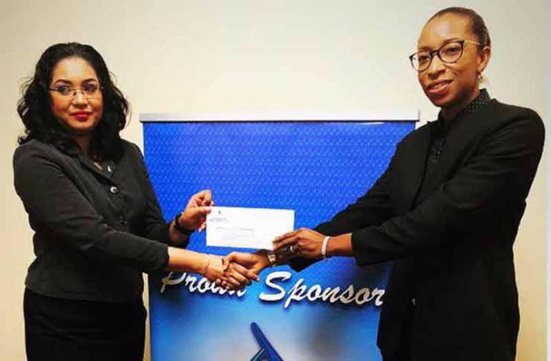 GBTI’s Public Relations and Marketing Manager, Pamela Binda, (left) hands over the bank’s sponsorship cheque to GLTA vice-president Cristy Campbell.