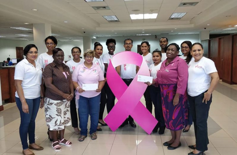 Staff of GBTI making their contribution to  President of the Guyana Cancer Foundation Ms. Bibi Hassan,  Ms. Cheryl Caines and Miriam Williams of the Periwinkle Club
