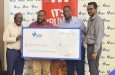 GBTI CEO Shawn Gurcharran (far right) looks on as GBTI Senior Marketing Manager Pernell Cummings present the cheque to Petra’s Troy Mendonca in the presence of Petra’s Troy Peter