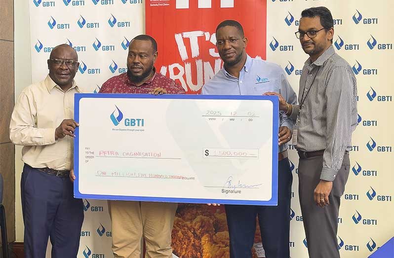 GBTI CEO Shawn Gurcharran (far right) looks on as GBTI Senior Marketing Manager Pernell Cummings present the cheque to Petra’s Troy Mendonca in the presence of Petra’s Troy Peter