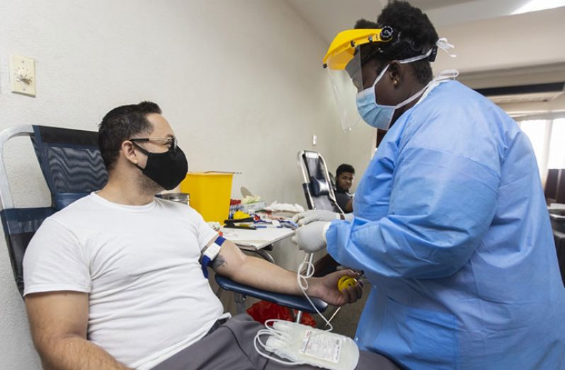 GBTI staff member, Christopher Mackintosh, donating blood