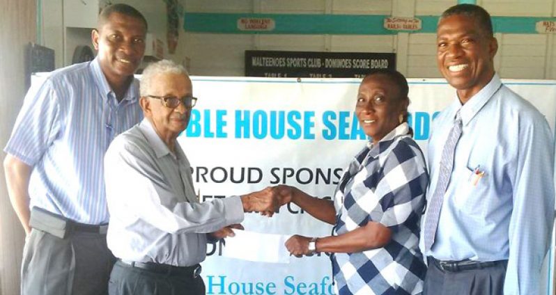 GCA secretary Deborah McNichol collects the sponsorship cheque from Noble House Seafoods representative, Piercy Corlette, in the presence of other GCA officials.