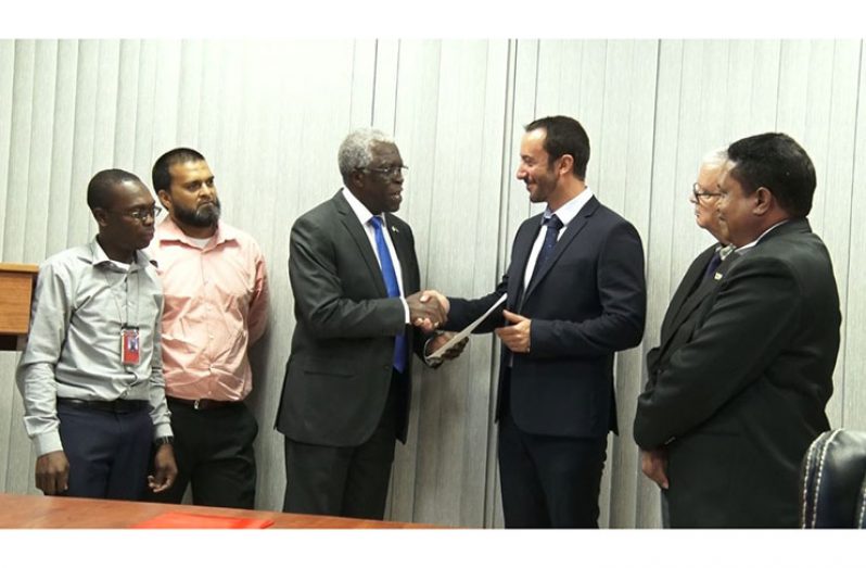 GCAA Director-General, Lieutenant Colonel (Retd) Egbert Field presenting TLC Guyana Inc. official, Mathiev Guiraud with the Helideck licence for Lisa Destiny at GCAA’s Headquarters