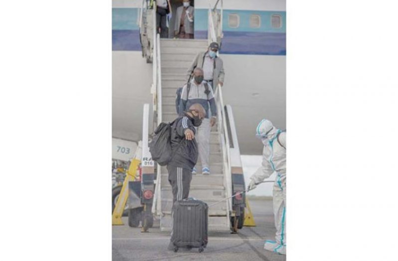 Returning Guyanese being sanitised upon entry at the CJIA (DPI photo)