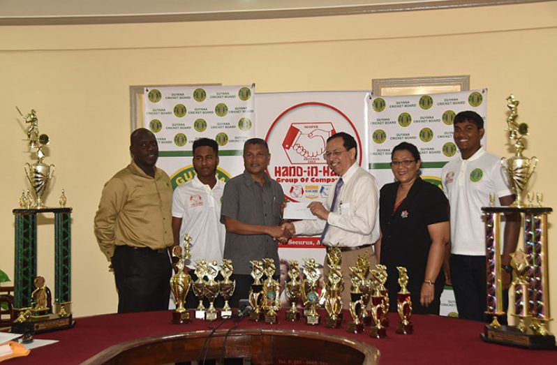 GCB secretary Anand Sanasie (third left) collects the sponsorship cheque from Hand-in-Hand Mutual Fire Director Howard Cox. Also sharing the moment are GCB TDO Colin Stuart, Hand-in-Hand Human Resource/Admin Manager Zaida Joaquin and cricketers Bhaskar Yadram and Joshua Persaud.