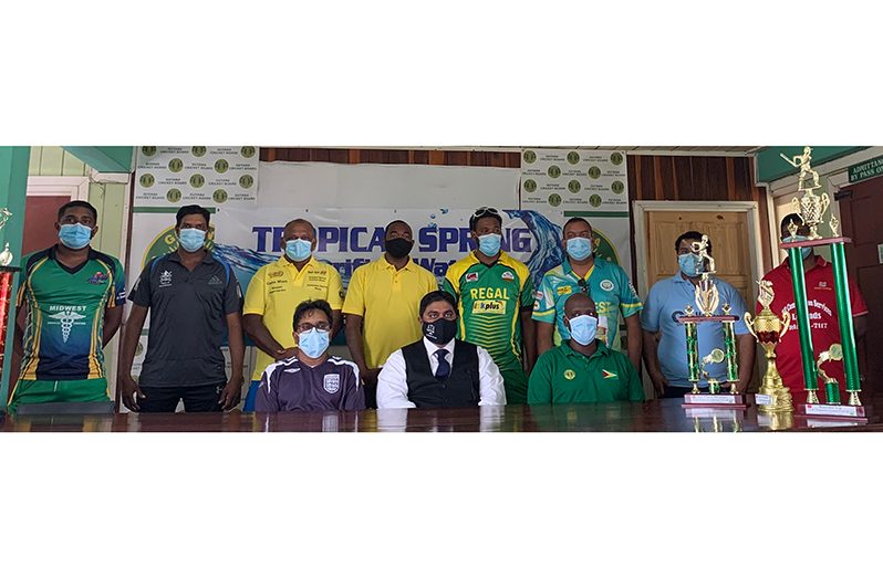 A few of the Over-40 team reps along with GCB executives (sitting front row) share a photo with the trophies, ahead of today's first round start.