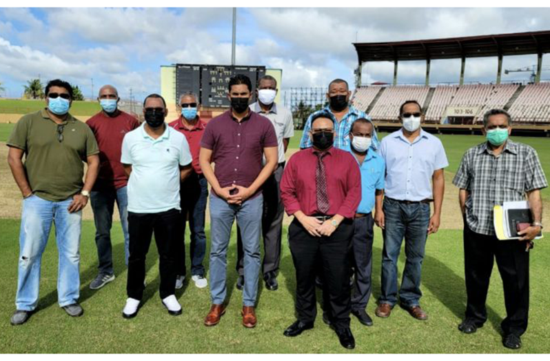 Minister of Sport, Charles Ramson Jr, alongside GCB president Bissoondyal Singh (both at centre), and flanked by other GCB executives, following their visit to the Guyana National Stadium at Providence.