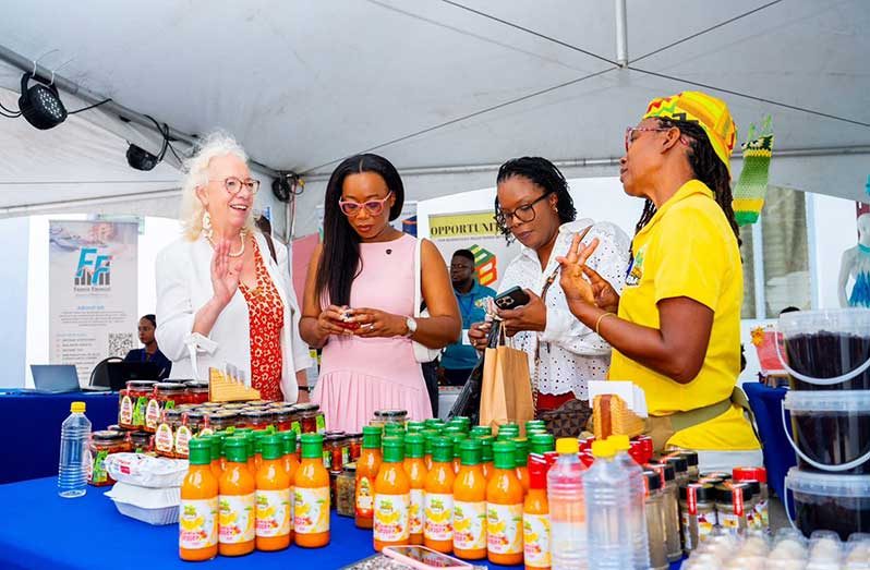 President of the Georgetown Chamber of Commerce and Industry (GCCI), Kathy Smith (second from the left), and the British High Commissioner to Guyana, Jane Miller, interact with entrepreneurs