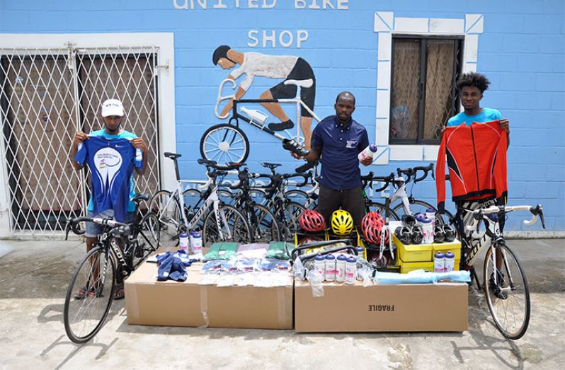 GCF president Horace Burrowes (centre) displays the donated equipment.