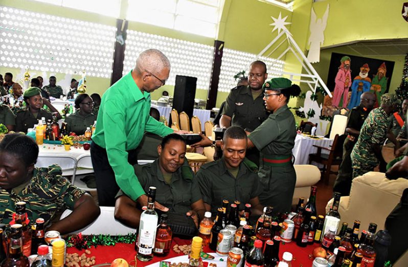 President David Granger participated in the distribution of food at the 
Soldiers’ Day event at Base Camp Ayanganna on Friday