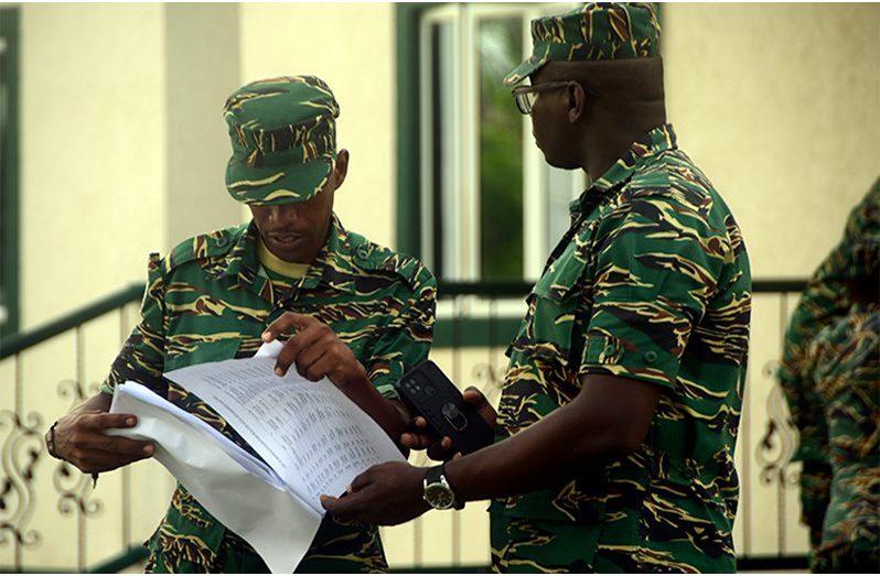 Flashback: Local government elections 2023, GDF ranks check the voters’ list for their names (Adrian Narine photo)