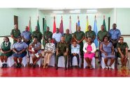 Chief of Defence Staff, Brigadier Omar Khan, MSS (seated at centre) flanked by the ten senior non-commissioned officers who were badged, along with special invitees