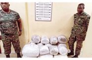 GDF Sergeants Adisa Higgins and Colvis Sam standing next to the marijuana they were allegedly caught with