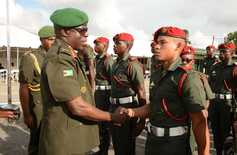 Chief of Staff Brigadier Patrick West congratulates one of the many ensigns after the parade