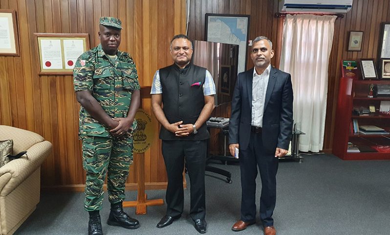 Corporal Trevon Jeffers shares a light moment with High Commissioner of India to Guyana, Dr KJ Srinivasa (centre) and another official