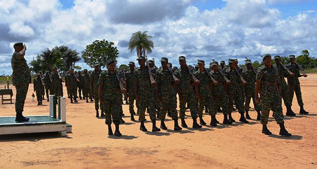 GDF Chief of Staff, Brigadier Mark Phillips, taking the salute during the March Past exercise at the Colonel John Clarke Military School, Tacama, at the conclusion of the course