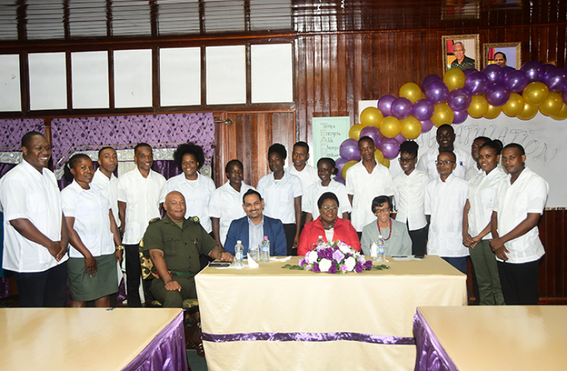 From left, Major Earl Edghill of the Guyana Defence Force; Director of The Tourism and Hospitality Association of Guyana, Mr Mitra Ramkumar; Principal of The Carnegie School of Home Economics, Ms Myrna Lee; and Chairperson of The Carnegie School of Home Economics, Ms. Patricia David, along with the graduates. ( Adrian Narine photos)