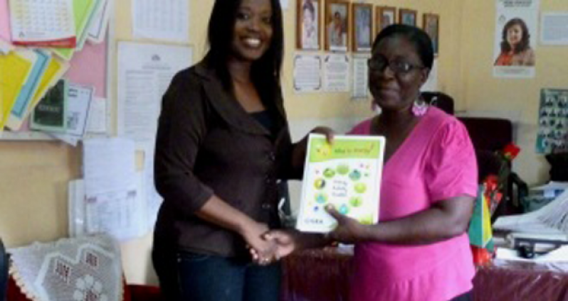 St Margaret’s Primary Head Teacher, Ms Georgiana Lewis, receiving the booklets from GEA’s Public Communications Officer, Taiwo Wilson-Williams