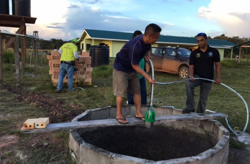 Men operating the pump installed by GEA at Wowetta