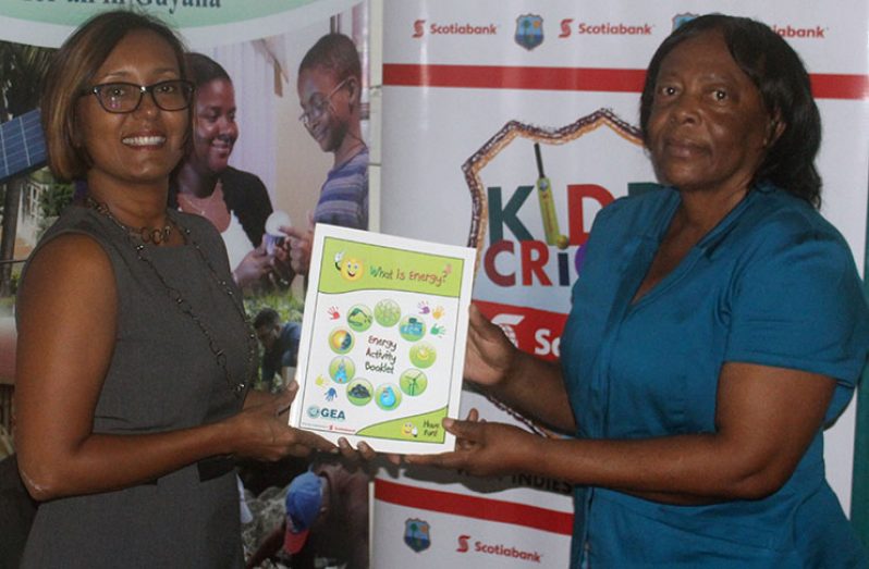 Scotiabank's Marketing Manager, Jennifer Cipriani hands over the booklets to GEA's Deputy CEO, Mrs Gayle Primo-Best.