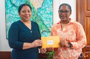 Chief Executive Officer of the Guyana Energy Conference, Kiana Wilburg presenting the tickets and complimentary passes to Vice-Chancellor of the University, Professor Paloma Mohamed Martin