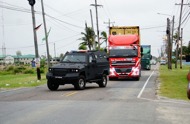 Containers containing the more than 2,000 ballot boxes being transported to the Arthur Chung Conference Centre under heightened police presence (Carl Croker Photo)
