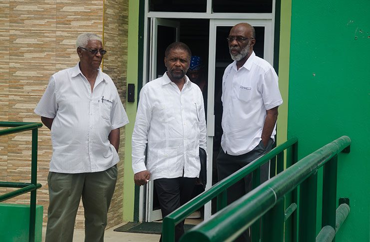 (From left to right) Commissioners Desmond Trotman, Charles Corbin and Vincent Alexander leaving the Ministry of the Presidency on Friday (Delano Williams photo)