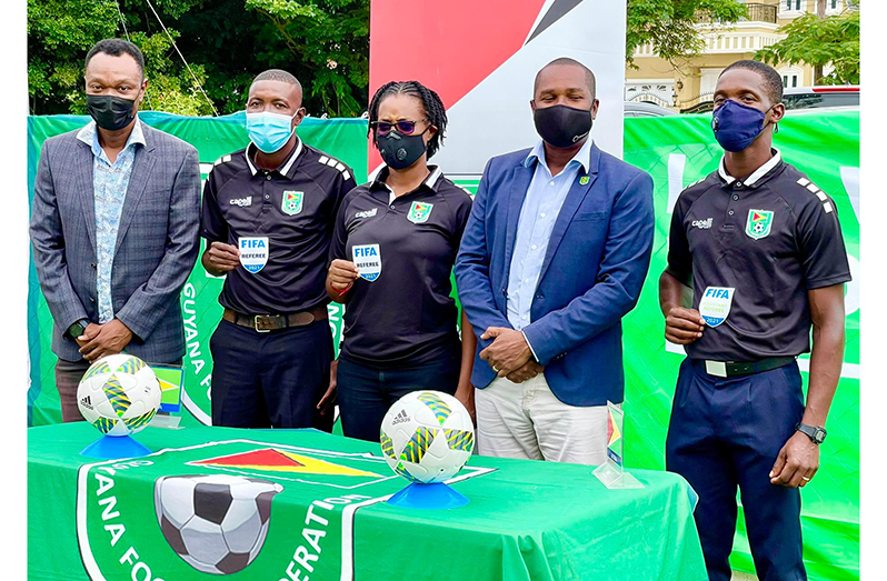 Guyanese officials Sherwin Johnson, Maurees Skeete and Kleon Lindey display their FIFA badges in the presence of GFF executive Dion Innis and president Wayne Forde.