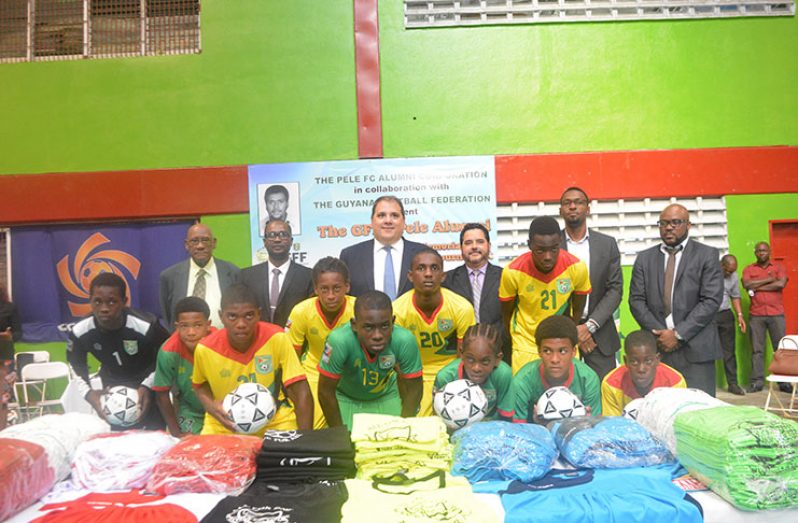 Some of the U-15 Guyanese football players with the officials: In the back row, from left, are: President of the Pele Alumni Corporation, John Yates, GFF president Wayne Forde, CONCACAF president Victor Montagliani, AFF president, Richard DijKhoff, Director of Sport, Christopher Jones and St Martin Football Association president Fabrice Baly.