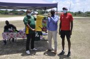 Caption:

 

GFF president Wayne Forde (2nd right) hands over a promotional poster to Coomacka United FC president Renison Rawlins in the presence of Abdullah Hamid.