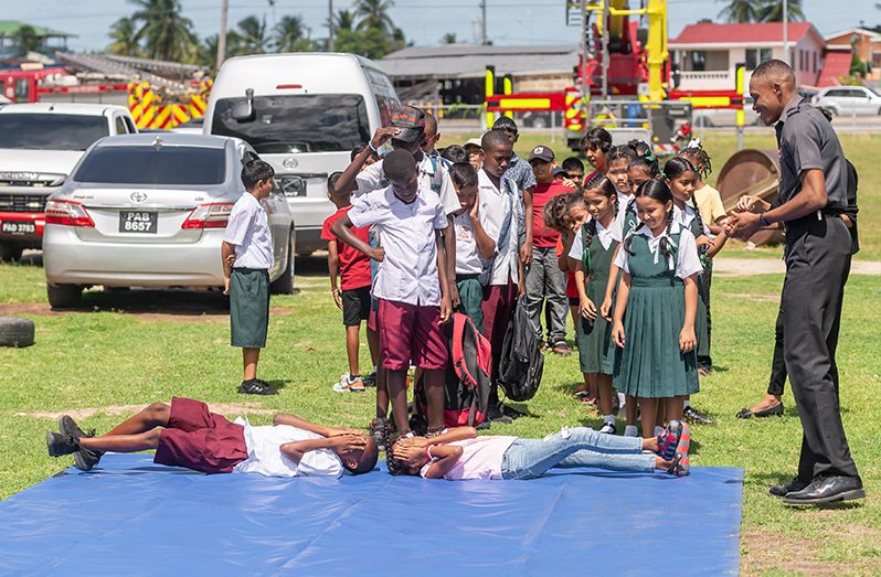 Children taking part in the stop, drop and roll demonstration at the Kids Camp