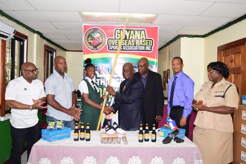 GOBSA president David Thomas (right centre) hands over the pair of javelins to CARIFTA Games female U-17 javelin gold medallist Anisha Gibbons, at the Independence Track & Field pre-competition press conference while other officials look on.