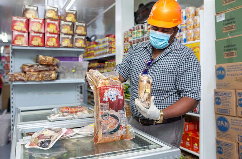 A Ministry of Health official examines the meat products